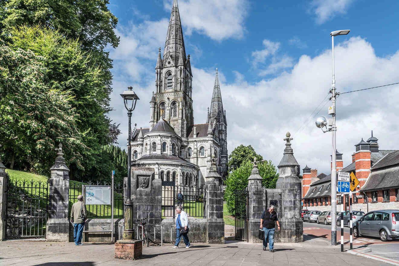 The exterior of a historic cathedral with gothic architecture in Cork Ireland, observed by pedestrians at the entrance.