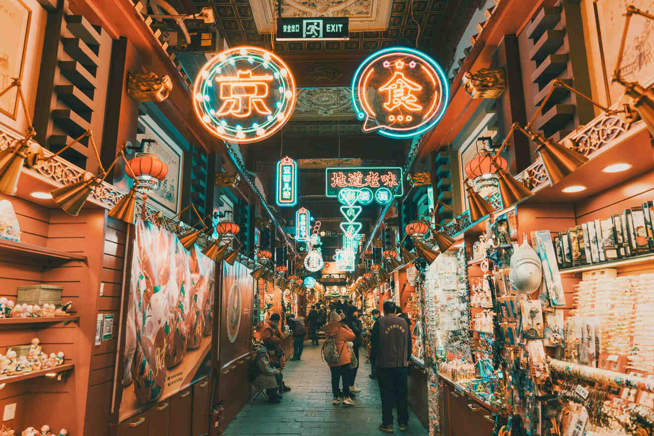 A vibrant market street in Beijing lit up with colorful neon signs and bustling with people