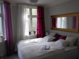 a hotel bedroom with a mirror above the bed