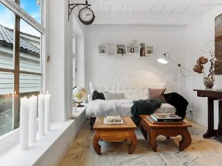 a living room with a white sofa and coffee tables
