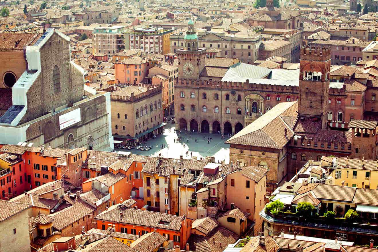 Aerial view of Piazza Maggiore in Bologna, highlighting the historic buildings, bustling squares, and terracotta rooftops.
