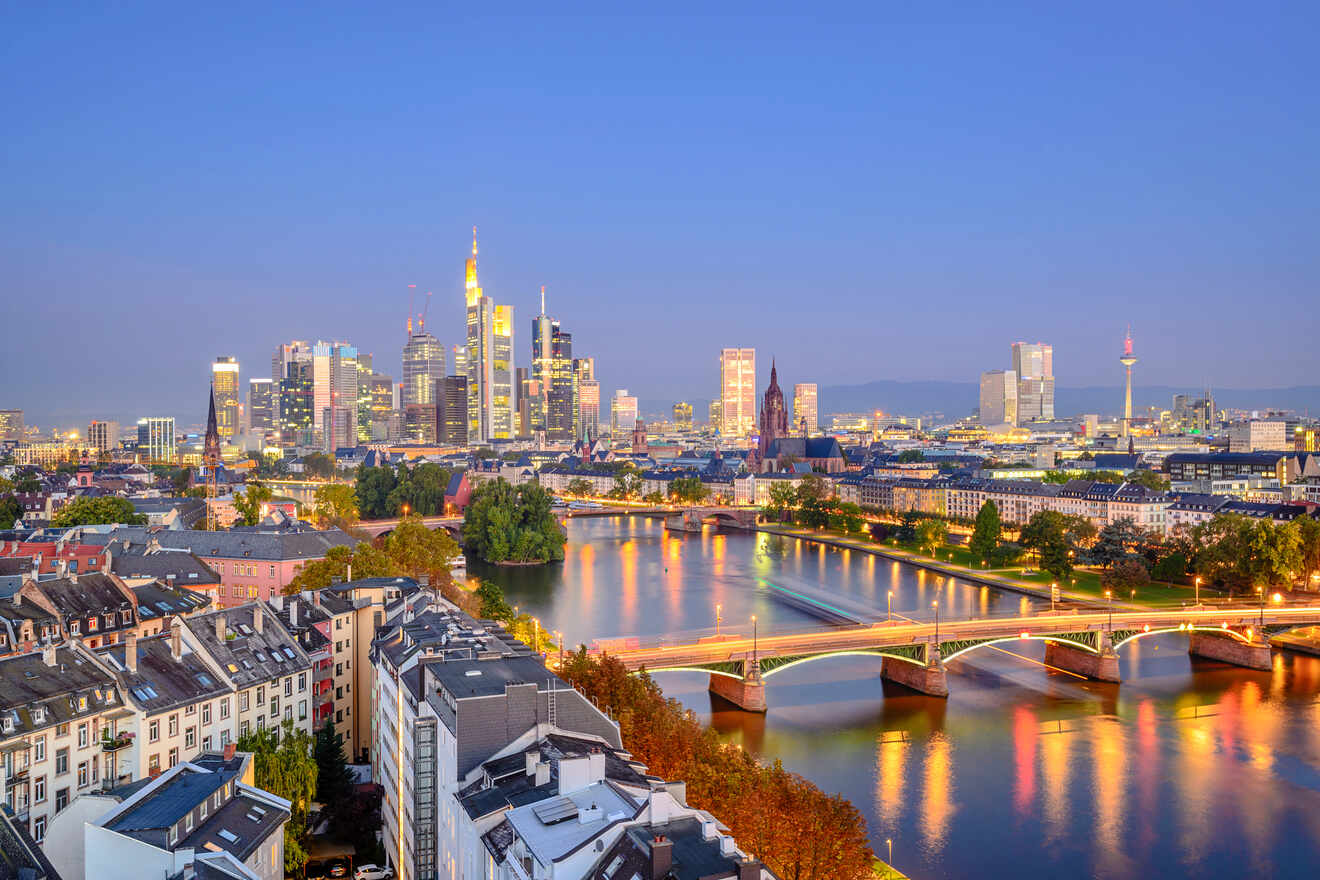 Twilight view of Frankfurt's skyline reflecting on the Main River, showcasing a blend of historic and modern architecture