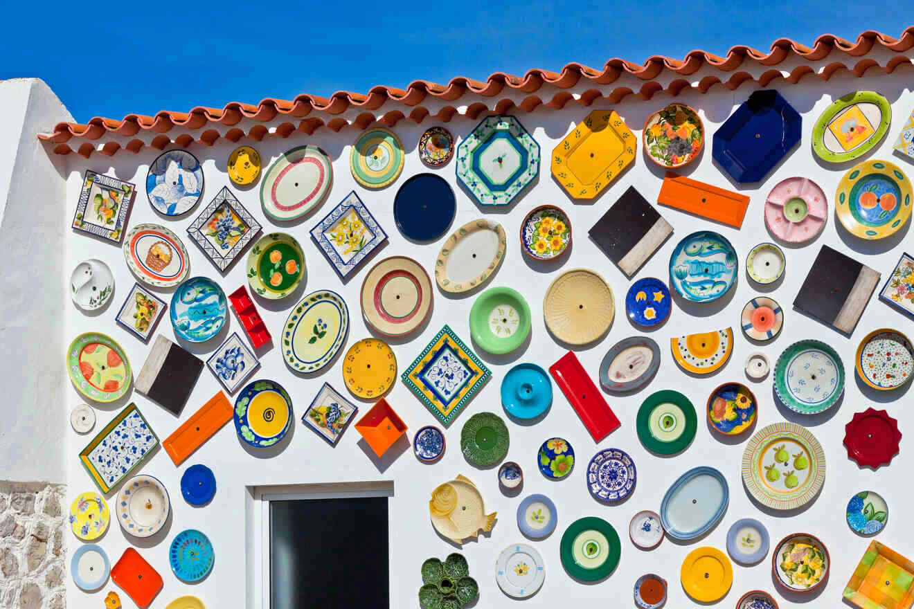 A wall of colorful plates on the side of a building.