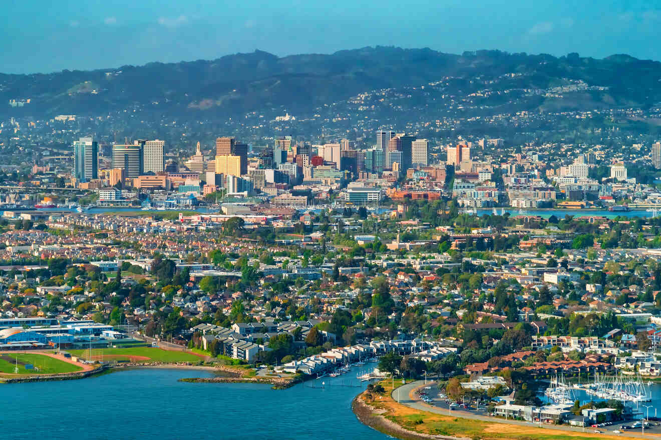 aerial view over the city with water in foreground and hills in the background