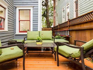 Cozy outdoor patio with comfortable lounge chairs and cushions on a wooden deck