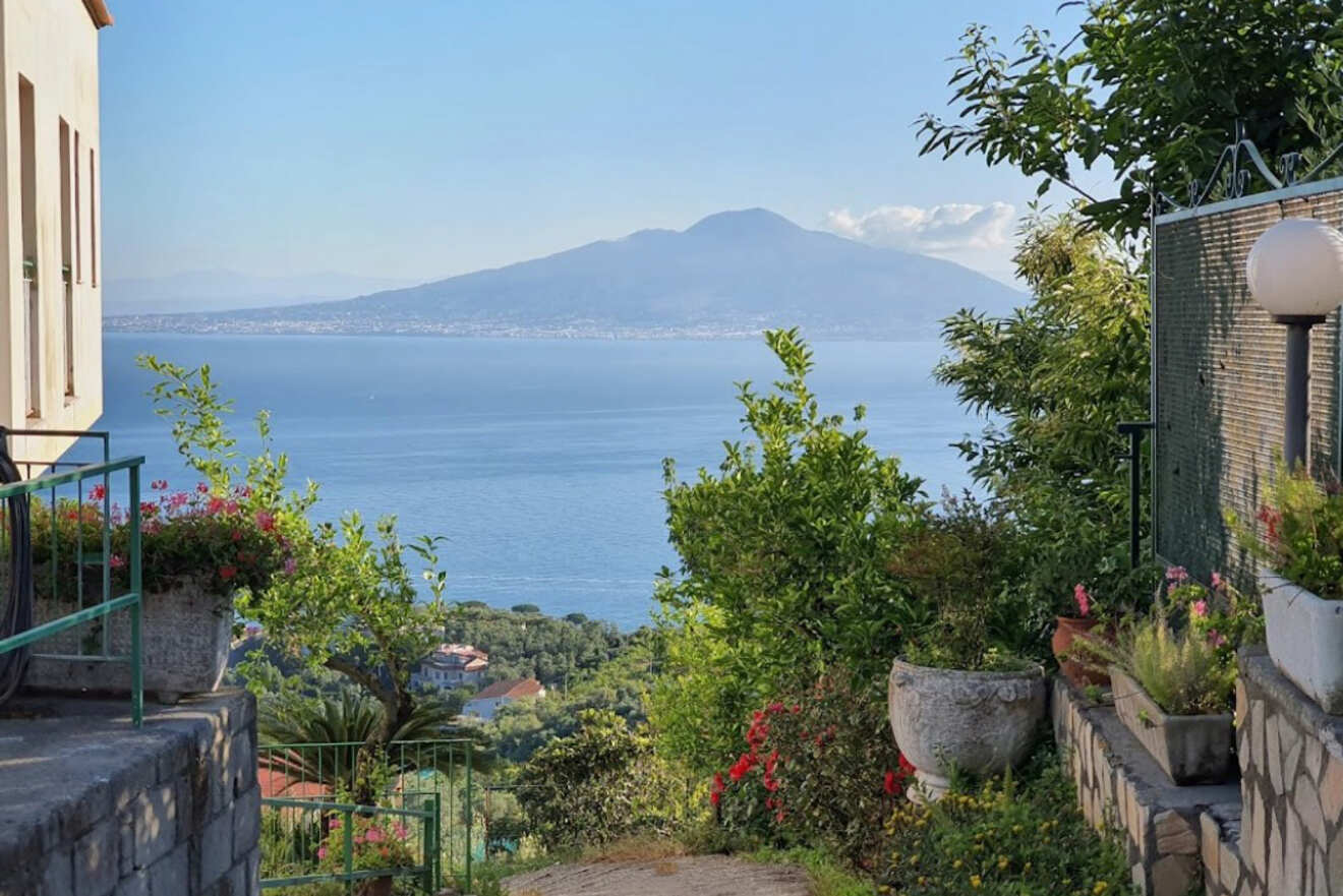 View from a hillside garden path overlooking the sea and Mount Vesuvius in the distance