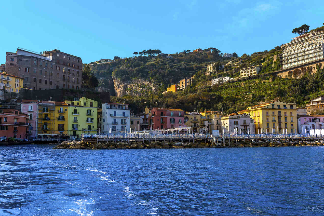 Seascape view of Sorrento's coastline with colorful buildings and a cliff in the background