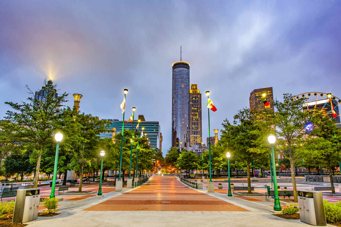 Centennial Olympic Park in Atlanta during twilight with illuminated pathways leading towards the city skyline and the iconic SkyView Ferris wheel