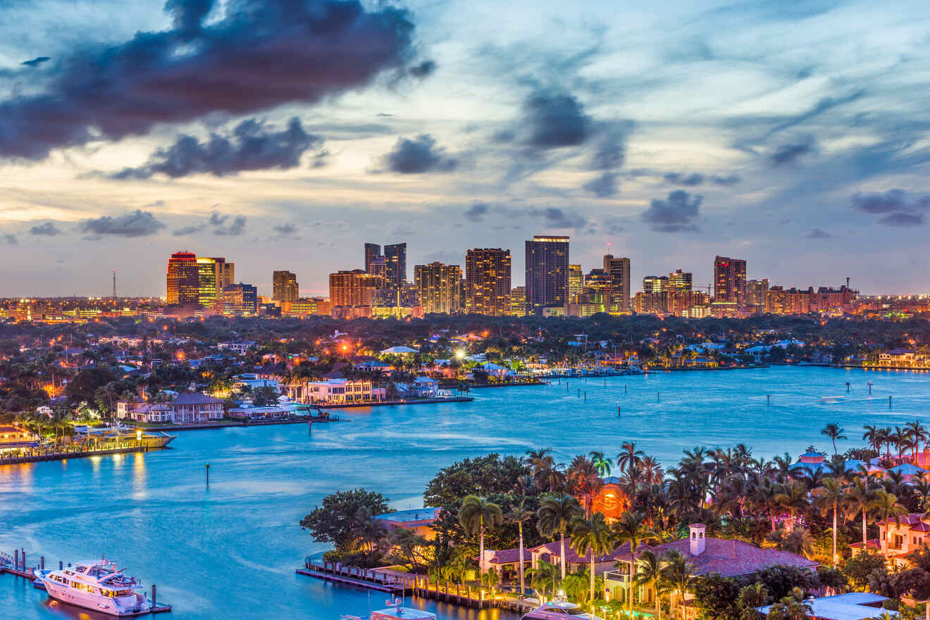 Dusk settles over a waterfront city skyline, where the fading daylight meets the twinkling city lights, reflecting a vibrant urban life by the calm waters