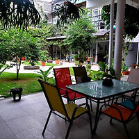 An outdoor patio with colorful chairs and a garden view.