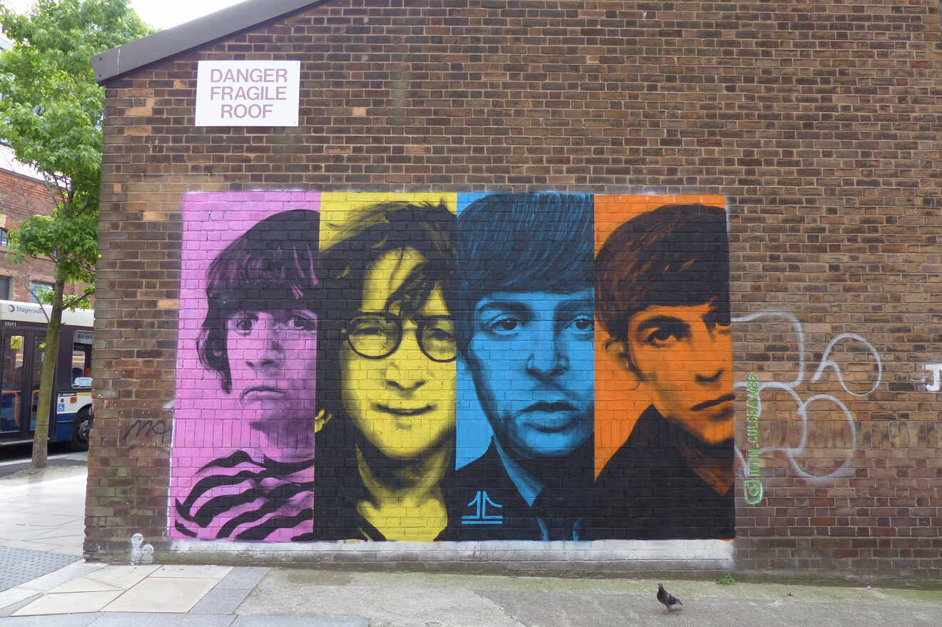 A colorful mural of The Beatles painted on a brick wall in Liverpool, commemorating the iconic band's legacy in their hometown