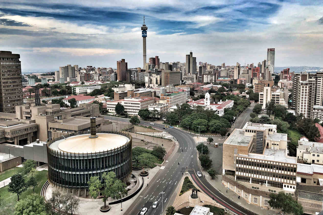 Elevated view of Johannesburg with the Hillbrow Tower prominent amongst other buildings, streets visible with light traffic