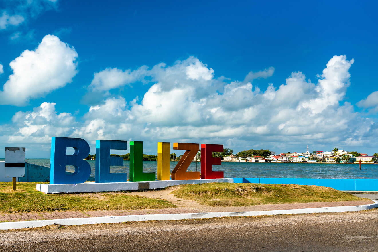 a large sign that says belize on the side of a road
