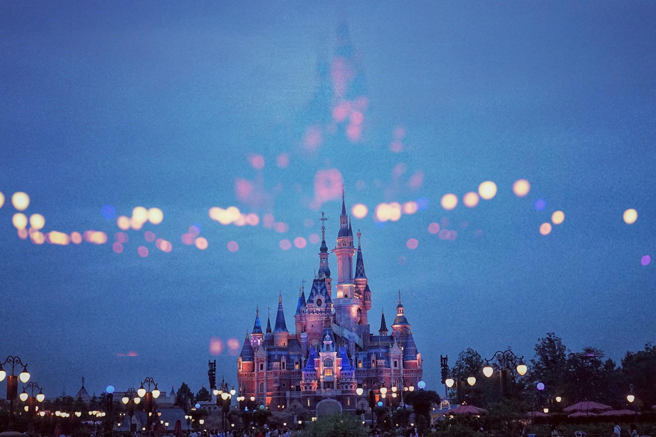 view of the castle in Disneyland Paris in the evening