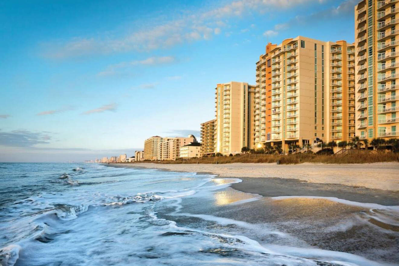 Scenic view of Myrtle Beach coastline with waves crashing on the shore and high-rise buildings in the background