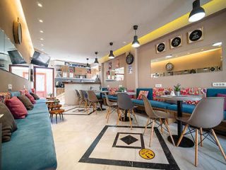 Modern cafe interior with colorful furniture, trendy decor, and a welcoming atmosphere.