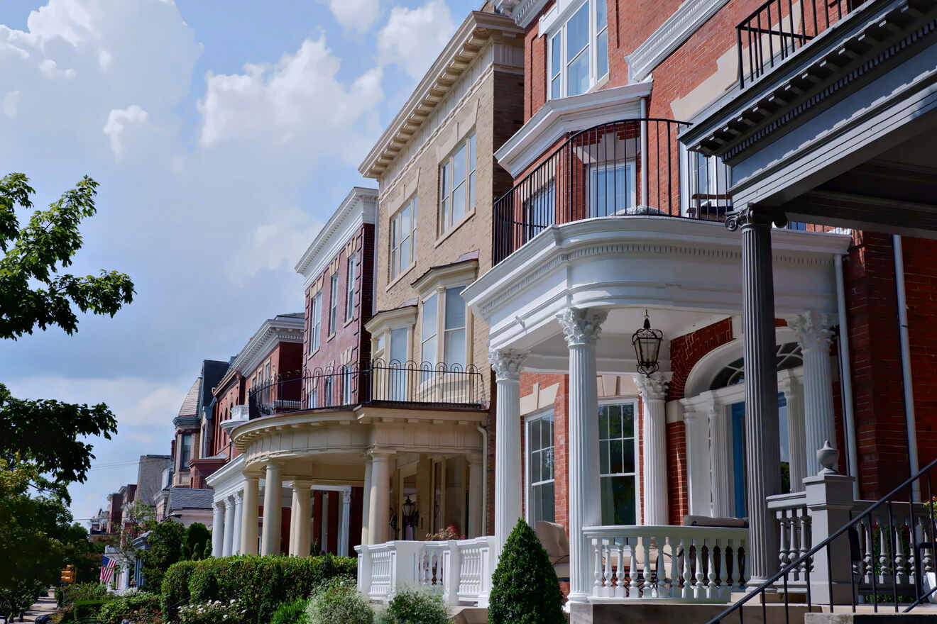Row of upscale townhouses with classic architecture and balconies in a charming neighborhood
