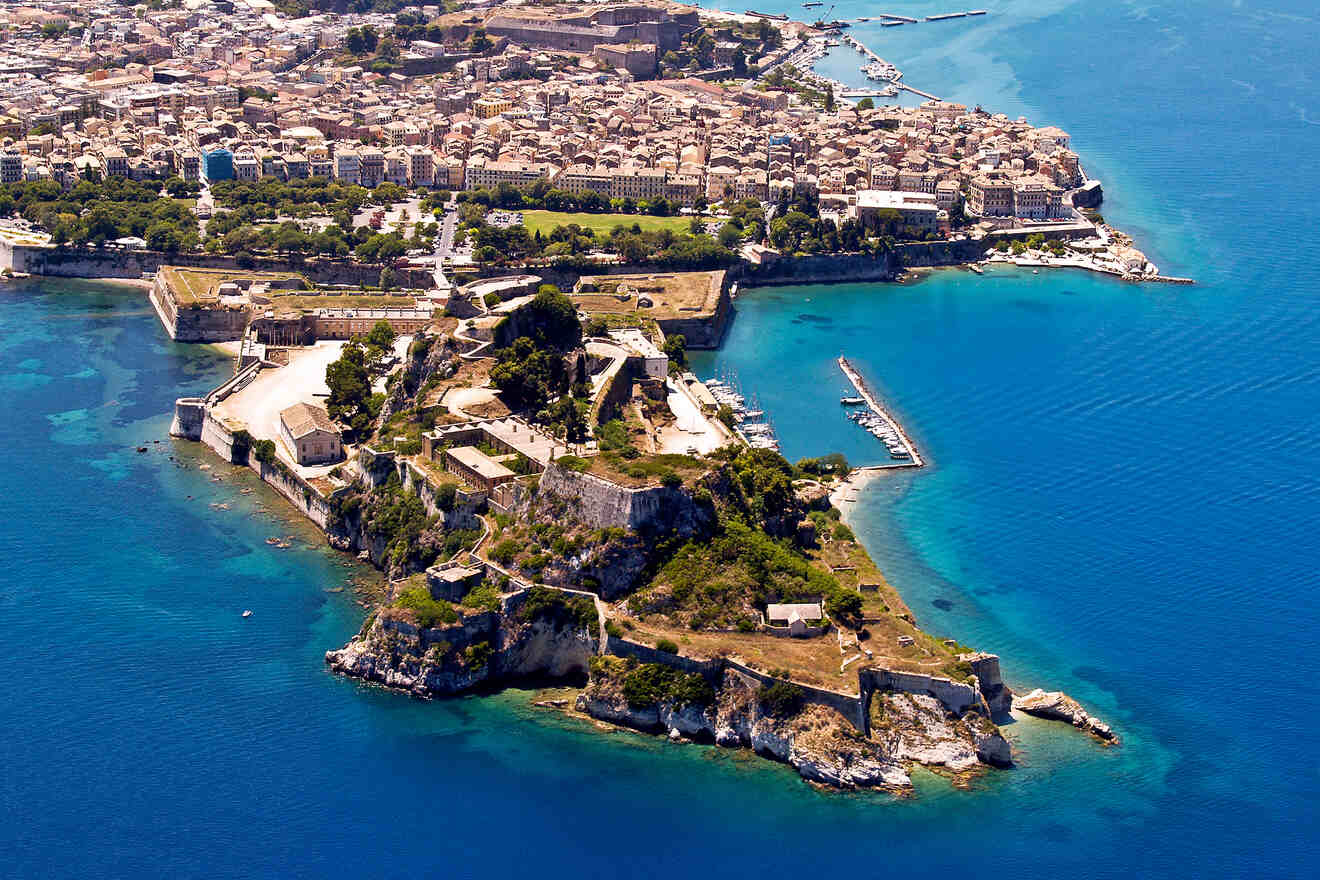 Aerial view of the old Venetian fortress in Corfu, surrounded by the Ionian Sea and the city's historical architecture.
