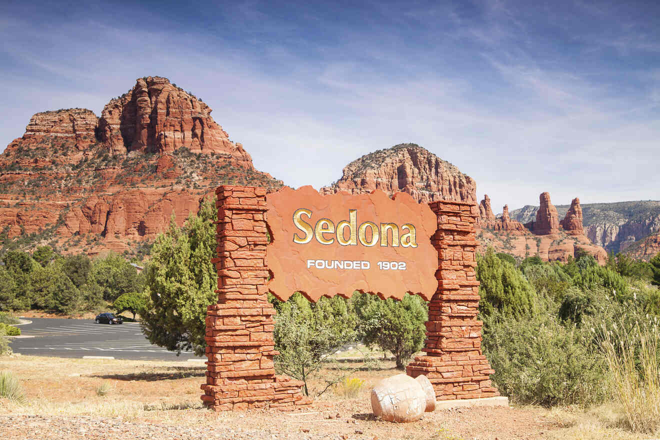 Iconic red rock welcome sign for Sedona with the year of founding, set against a backdrop of vibrant red rock formations and blue sky