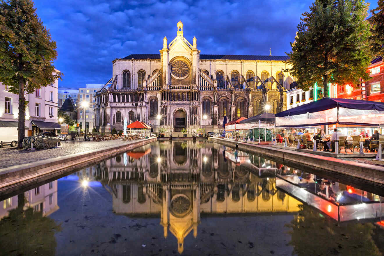 St. Catherine's Church in Brussels during twilight, reflected beautifully in the still water of the fountain