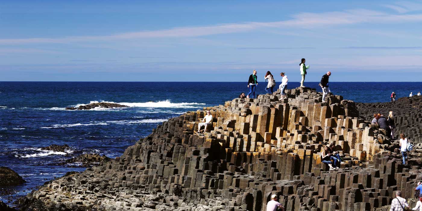 people standing on rocks