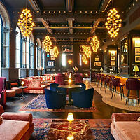 Luxurious interior of a vintage lounge with eclectic lighting and plush seating arrangements