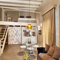 Cozy loft-style apartment interior with modern furnishings and warm lighting