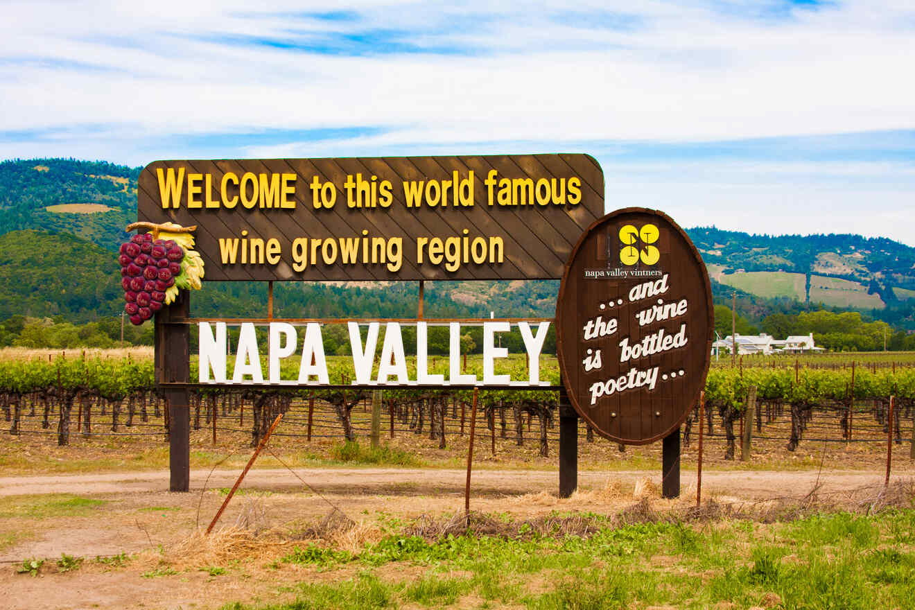 Sign reading "Welcome to this world famous wine growing region, Napa Valley, and the wine is bottled poetry" with vineyards and hills in the background.