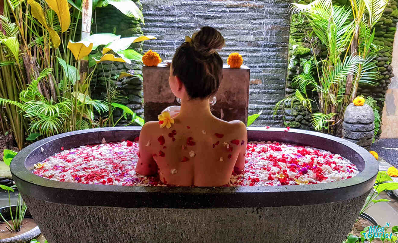 Girl in a spa bath with rose petals