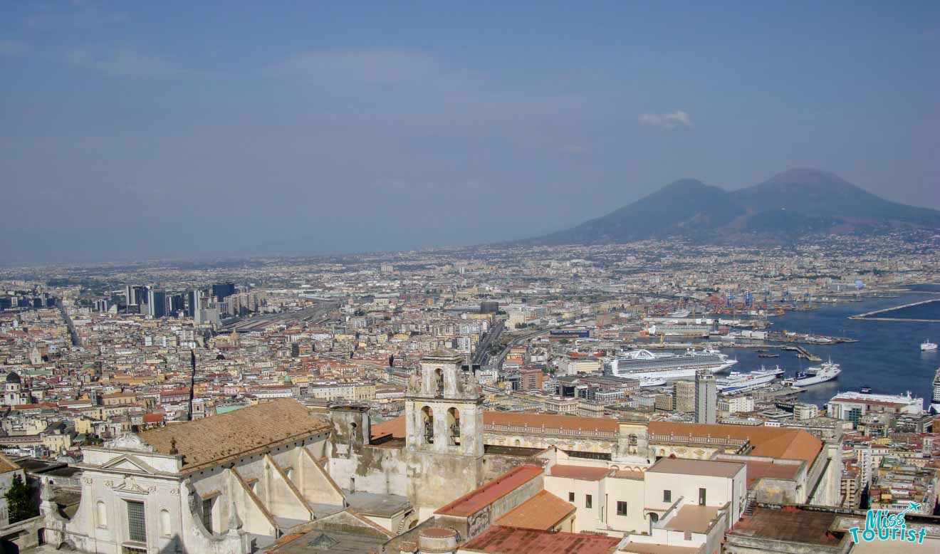 A view of the city of Naples with a mountain in the background.