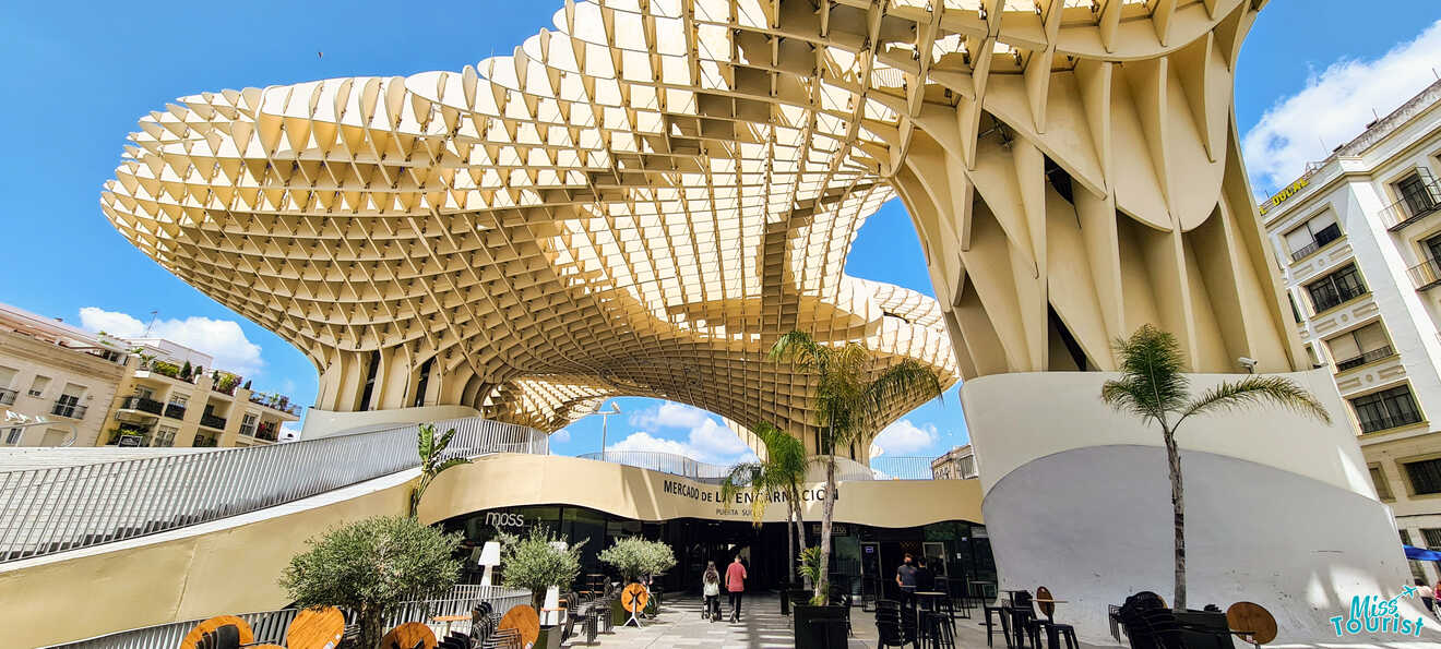 The Metropol Parasol in Seville, known as Las Setas, displays its unique waffle-like wooden structure soaring above an urban plaza, blending futuristic design with the city's historical charm