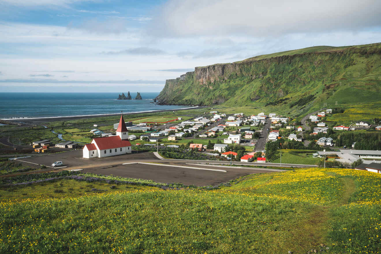 a small town on the side of a hill next to the ocean