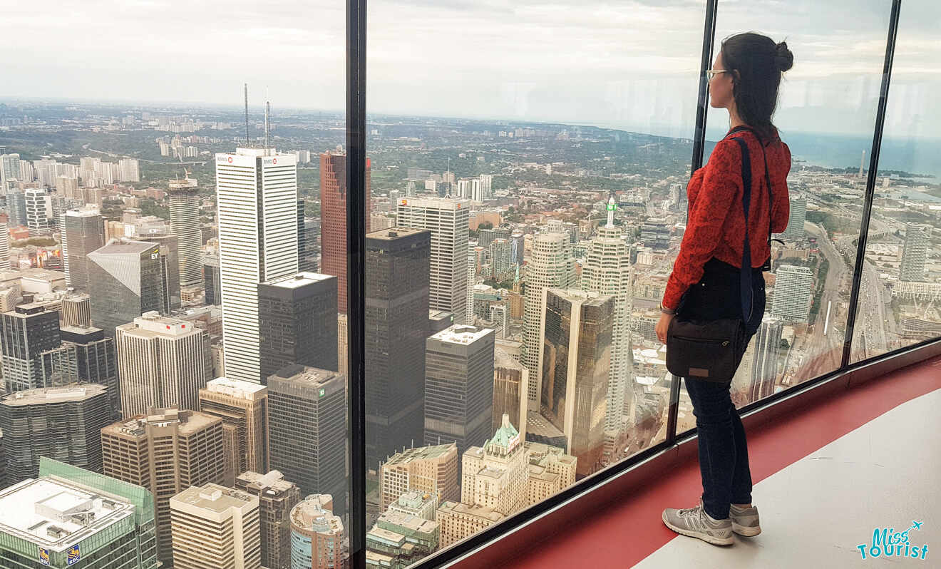 Girl looking out over view of the city from the CN Tower, one of the most popular things to do in Toronto
