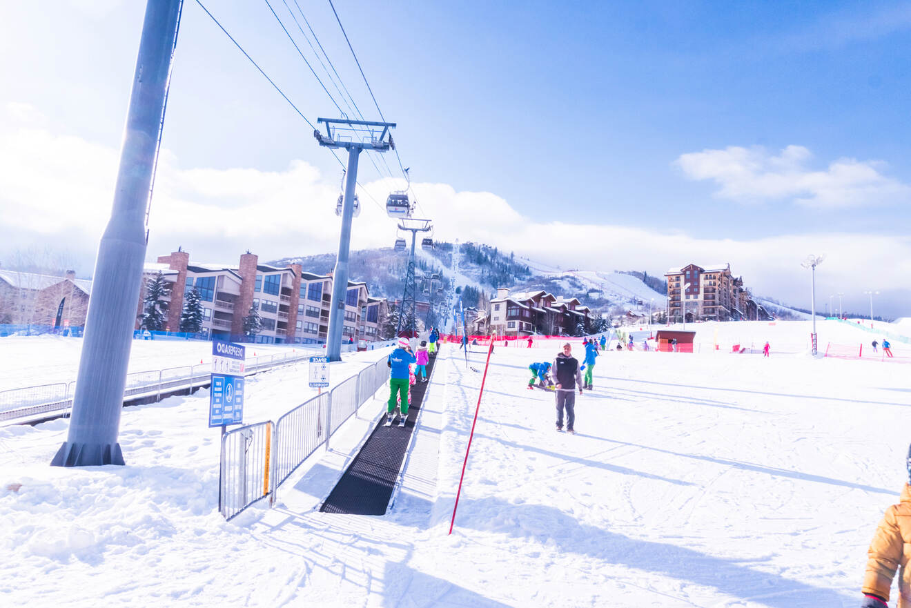 People riding a magic carpet at Steamboat Mountain Resort - one of the best places to stay in Steamboat Springs for skiing & hiking