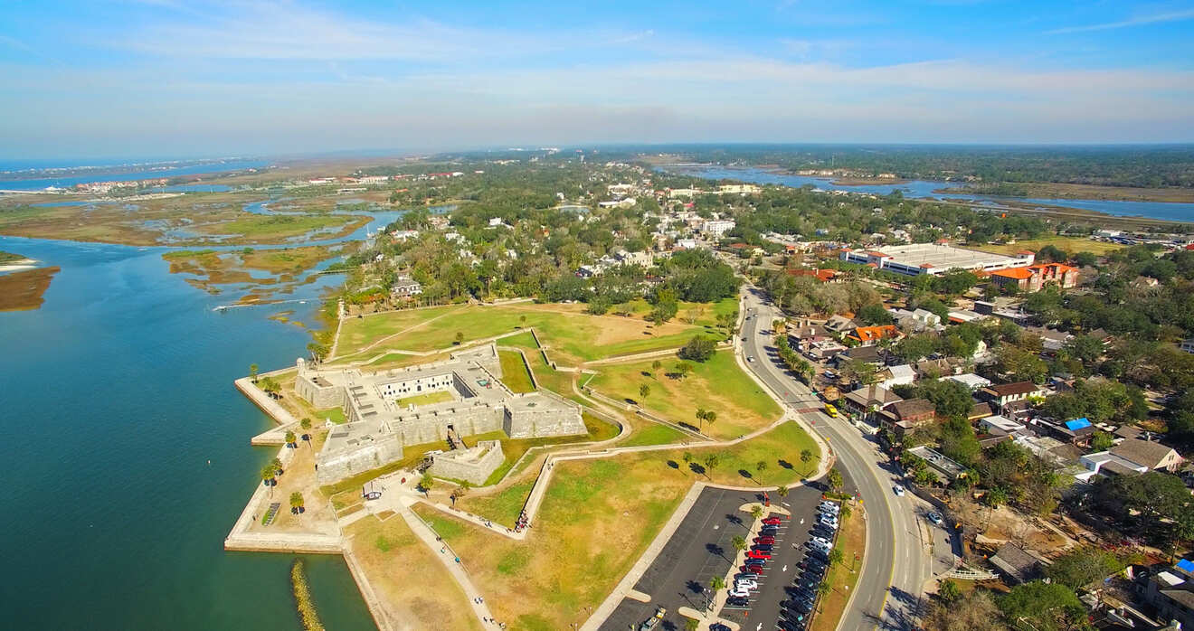 Aerial view of the historic Castillo de San Marcos in St. Augustine, Florida, with surrounding waterways and greenery.