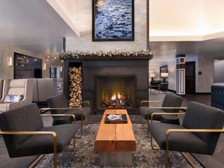 Elegant hotel lobby with a central fireplace, contemporary seating, and chic interior design elements