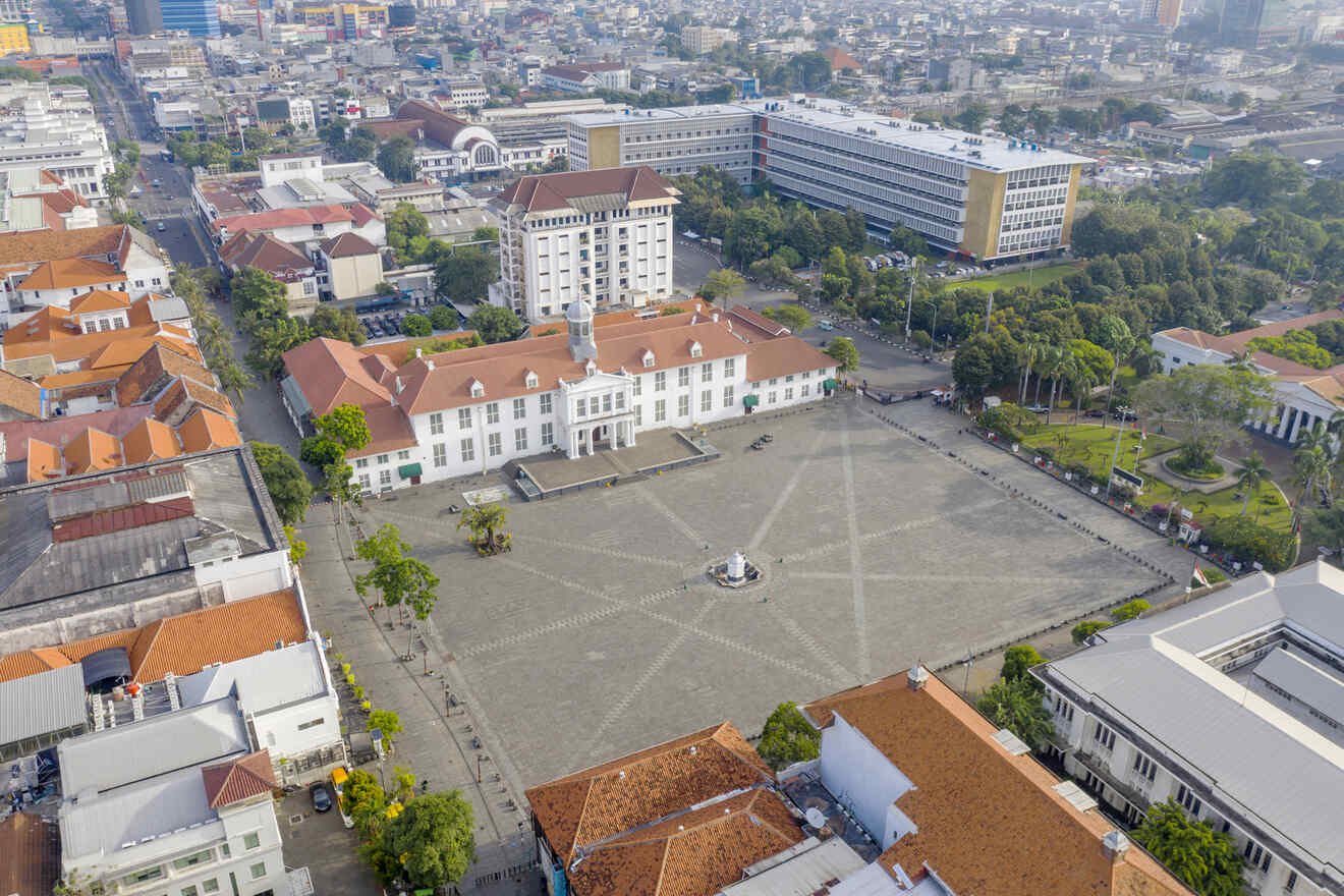 Aerial view of Jakarta's Fatahillah Square, surrounded by colonial-style buildings with red-tiled roofs