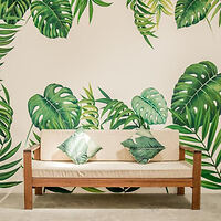 Interior design featuring a minimalist beige couch against a wall with a leaf print