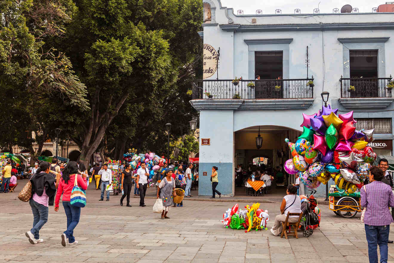 People walking through the colorful el Zocalo Square, one of the best things. to do in Oaxaca City