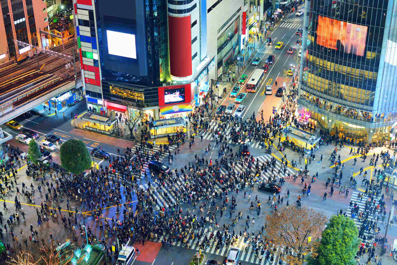 Overhead view of Shibuya Crossing in Tokyo with crowds of pedestrians and vibrant city lights