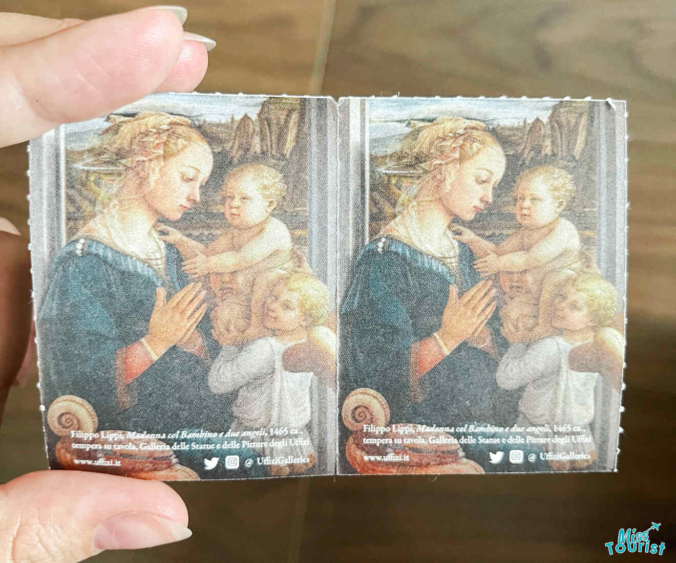 A picture of the Uffizi Gallery tickets featuring a painting of a lady and two babies