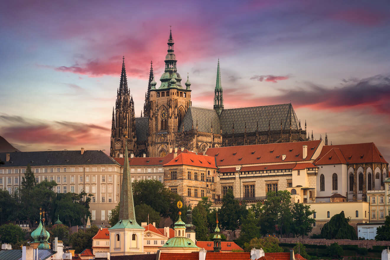 view of the Prague castle behind buildings at dusk