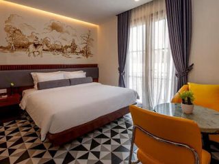 A stylish hotel room with a traditional Cambodian mural