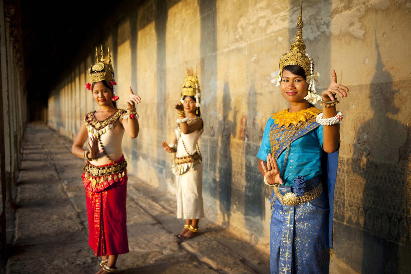 Traditional Cambodian dancers in vibrant attire, performing at the historic Angkor Wat temple, showcasing Cambodia's rich cultural heritage