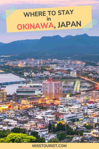 Aerial view of a city at dusk with numerous buildings, roads, a body of water, and surrounding mountains. Text at the top reads: "Where to stay in Okinawa, Japan.