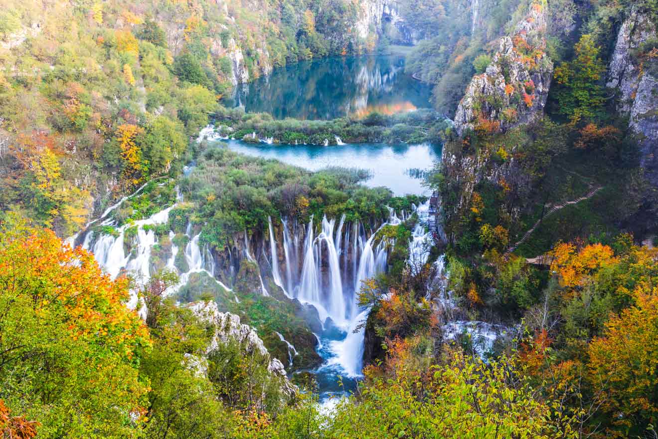 Aerial view of Plitvice Lakes' waterfalls amidst autumn-colored trees
