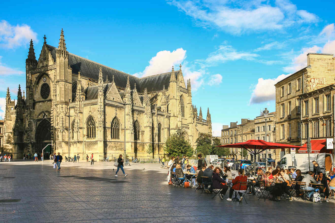 People are sitting in a square in front of a cathedral in Gare Saint Jean Saint Michel in Bordeaux