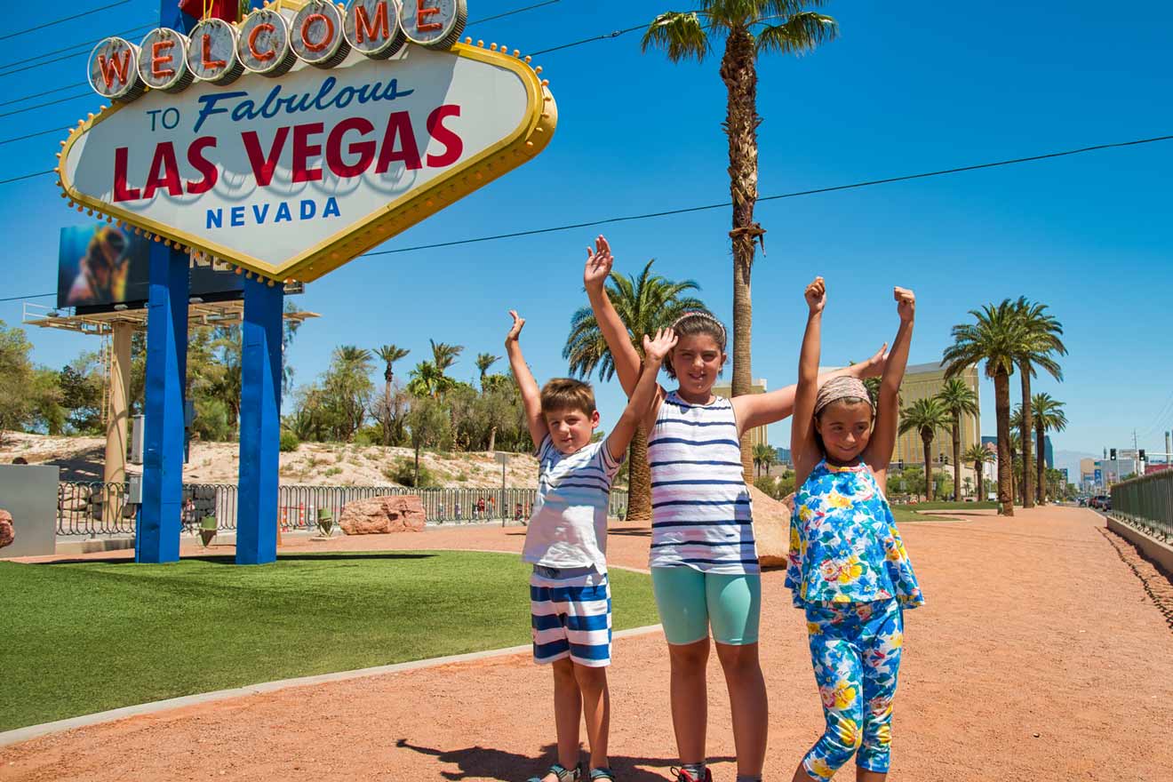 kids standing next to a Las Vegas sign