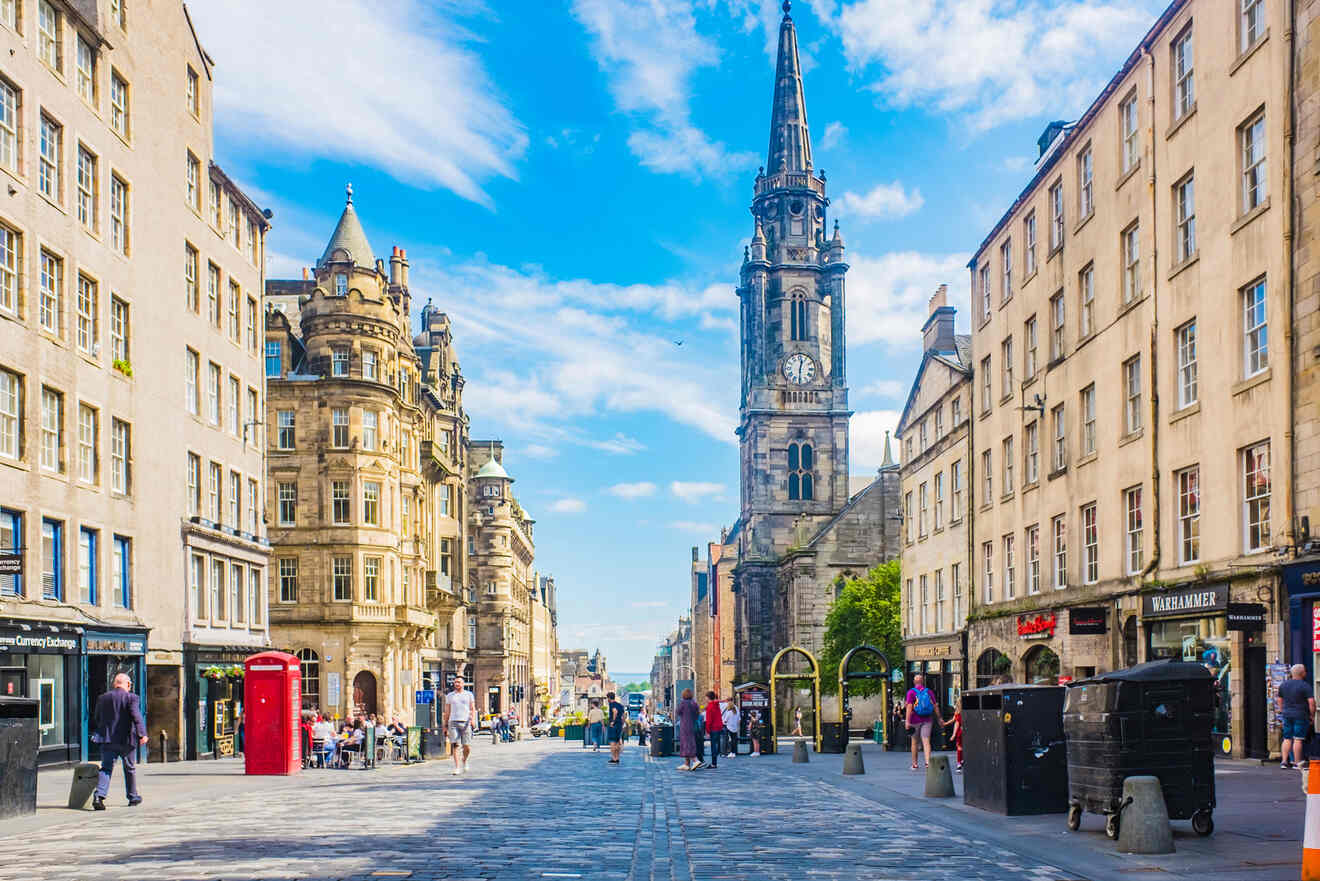 a city street lined with tall buildings and a clock tower