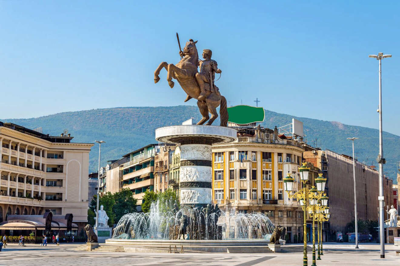 a statue of a man riding a horse in front of a fountain